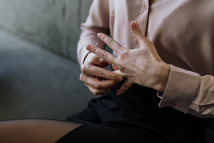 A woman taking off her wedding ring